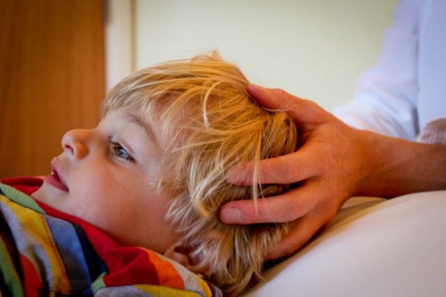hands on boy's head